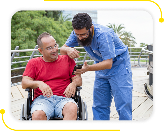 A picture of a caregiver taking care of an individual on a wheelchair