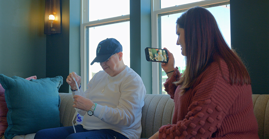 A staff at RRSI is filming a person with disability doing some activities